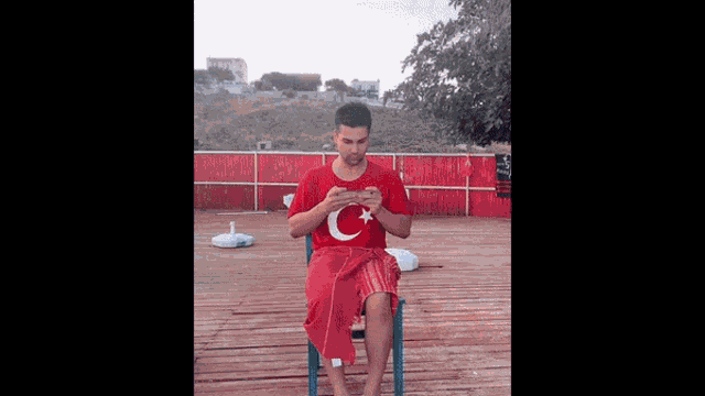 a man wearing a red shirt with a c on it