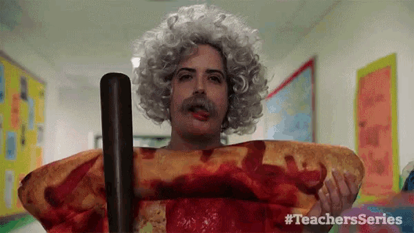 a man in a wig and mustache is holding a slice of pizza and two baseball bats .