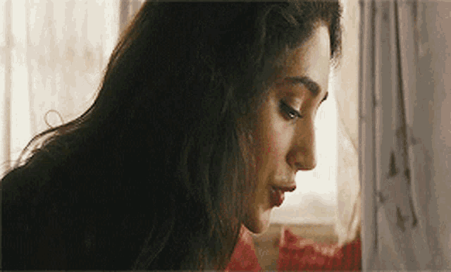 a close up of a woman 's face looking down