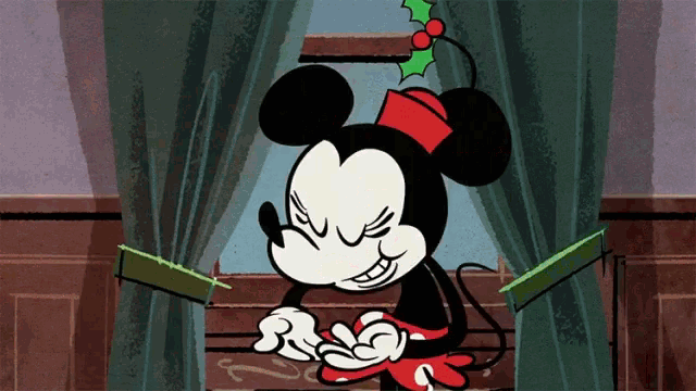 a cartoon drawing of mickey mouse wearing a red hat with holly on it