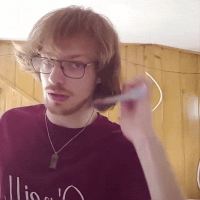 a man wearing glasses and a red shirt that says ' lions '