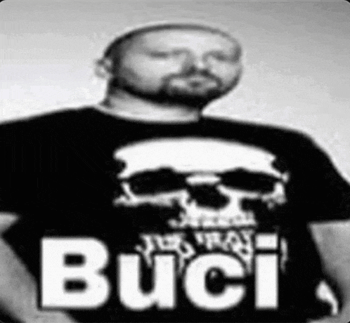 a man with a beard is wearing a black shirt with a skull on it that says buci
