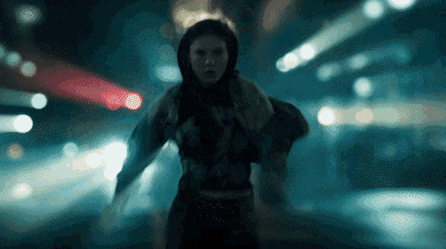 a blurry picture of a person walking down a street at night