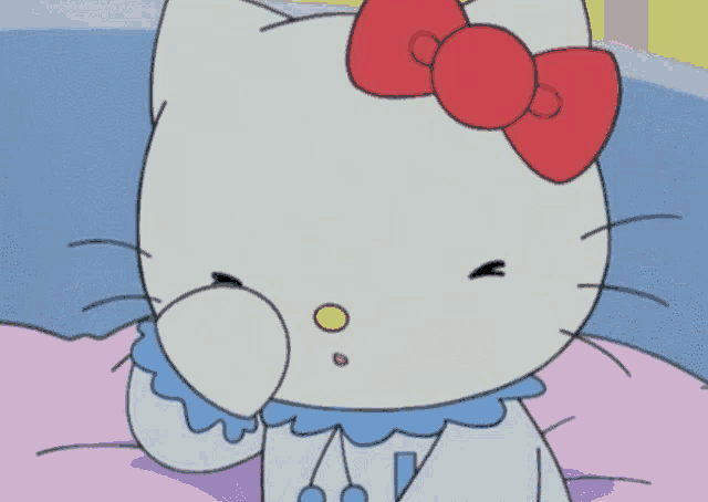 a hello kitty with a red bow on her head