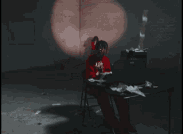 a young man wearing a red hoodie with the word supreme on it