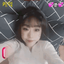 a girl with a cat ear on her head takes a picture of herself