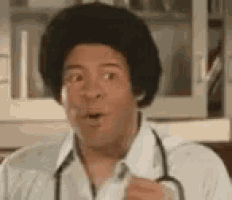 a man with an afro and a stethoscope around his neck is holding a syringe .