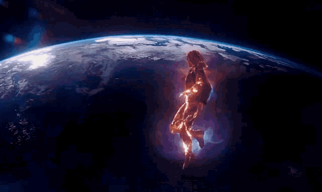 a woman in a superhero costume is flying through space