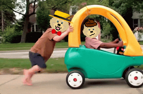 a man pushing another man in a toy car with a pixelated face on it