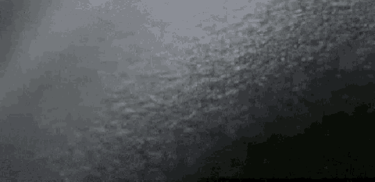 a gray background with a few white dots on it