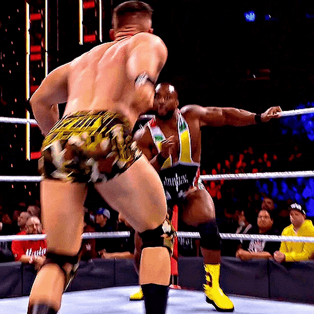 a man in a wrestling ring is wearing a shirt that says ' smackdown ' on it