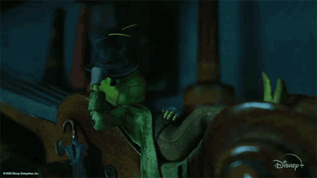 a disney animated character is sitting in a chair