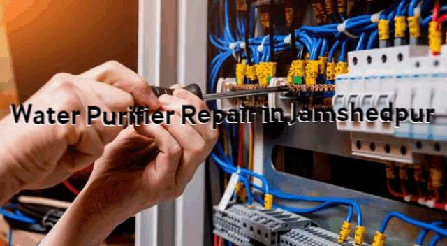 a person working on an electrical box with the words water purifier repair in jamshedpur below them