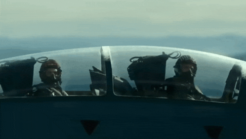 two pilots are in the cockpit of a plane