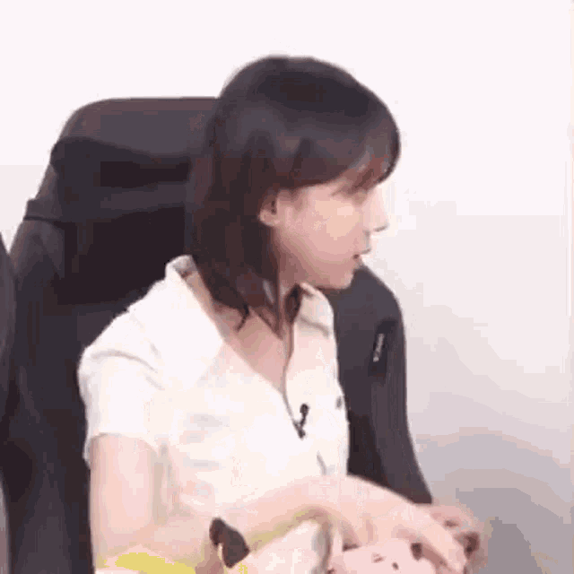 a woman is sitting in a chair with a microphone in her neck .