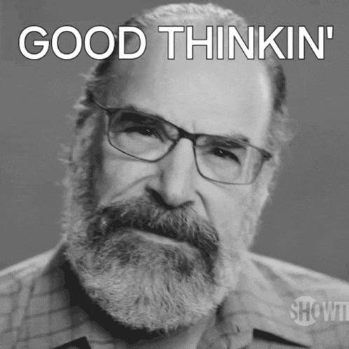 a man with glasses and a beard has the words good thinkin ' on his face