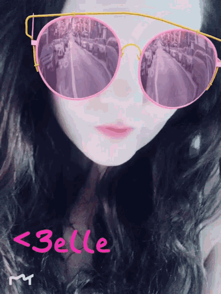 a woman wearing pink sunglasses has the name belle written in pink