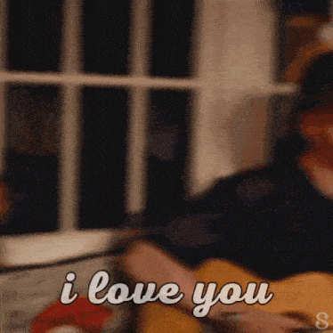 a man playing a guitar with the words " i love you " above him