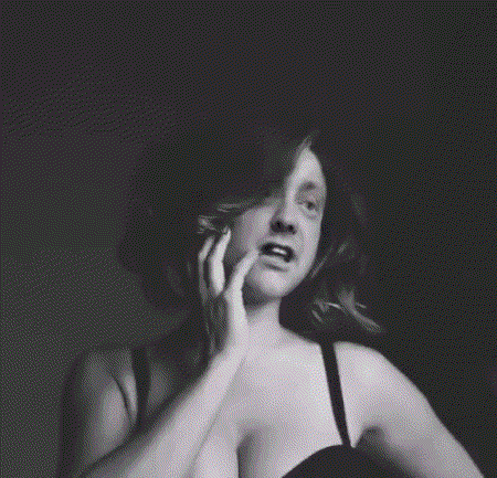 a black and white photo of a woman in a black bra
