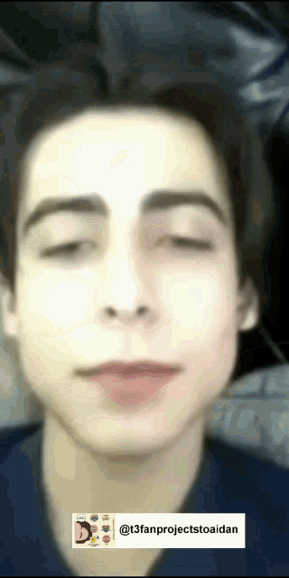 a close up of a young man 's face with his eyes closed and his mouth open .