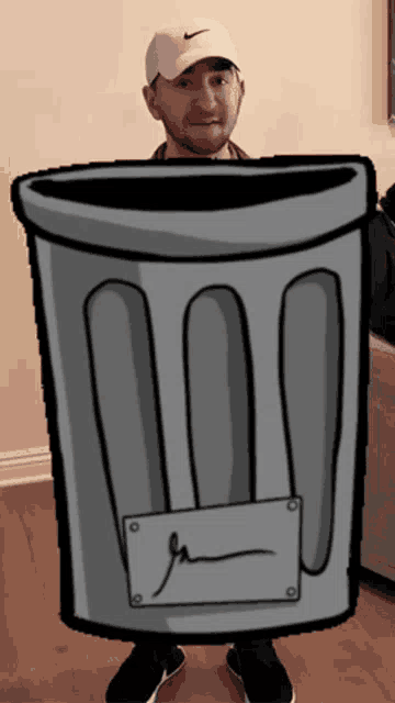 a man wearing a white nike hat is holding a cartoon trash can