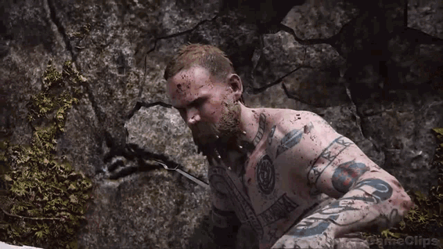 a man with a tattoo on his chest is being attacked by another man