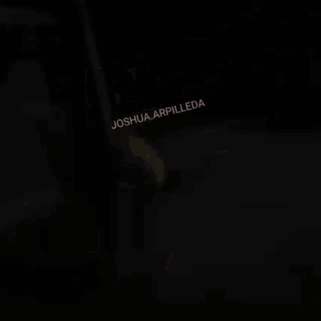 a blurred image of a group of people with the name joshua arpilleda on the bottom right