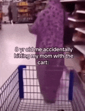 a person in a purple outfit is standing in a shopping cart in a grocery store .