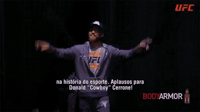 a man wearing a hat and a hoodie that says ufc on the bottom