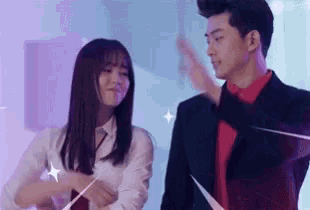 a man and a woman are standing next to each other and dancing .