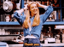 a woman is standing in a kitchen wearing a skirt that says thank you .