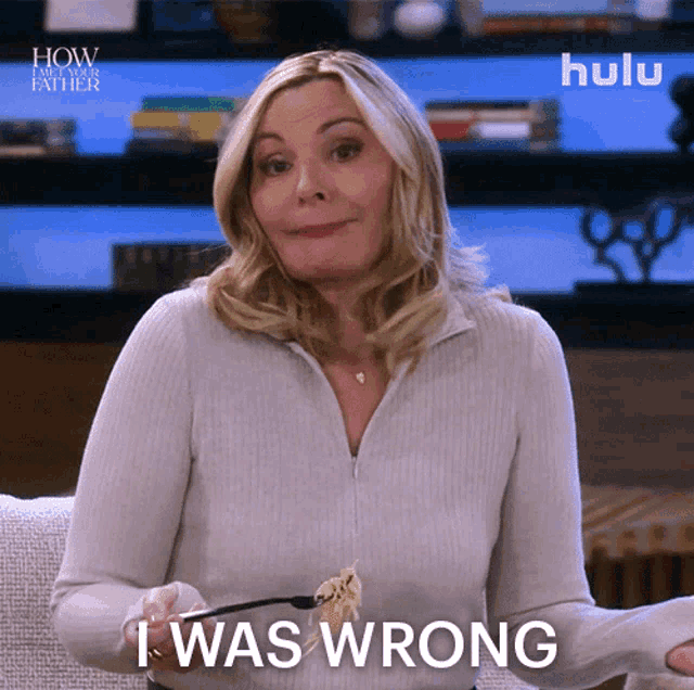 a woman is holding a fork and says " i was wrong "