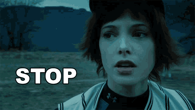 a close up of a woman 's face with the word stop written above her