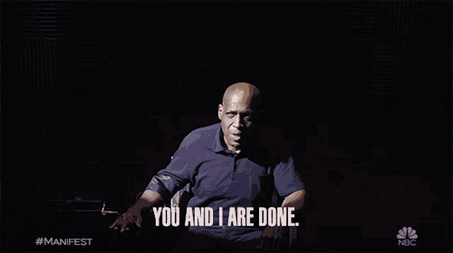 a man in a purple shirt says " you and i are done " in the dark