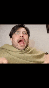 a man with a beard is making a funny face with his mouth wide open