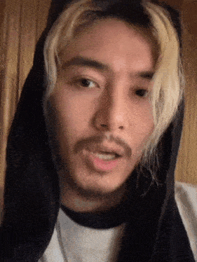 a man with a beard wearing a black hoodie