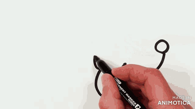 a person is drawing a cloud with a black marker that says made in animatica