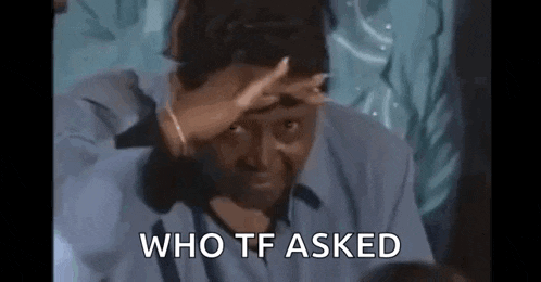 a man in a blue shirt is covering his face with his hand and the words `` who tf asked '' behind him .