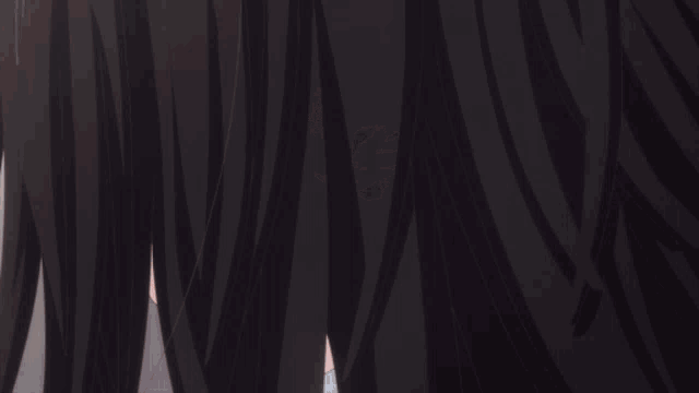 a close up of a girl 's face with dark hair