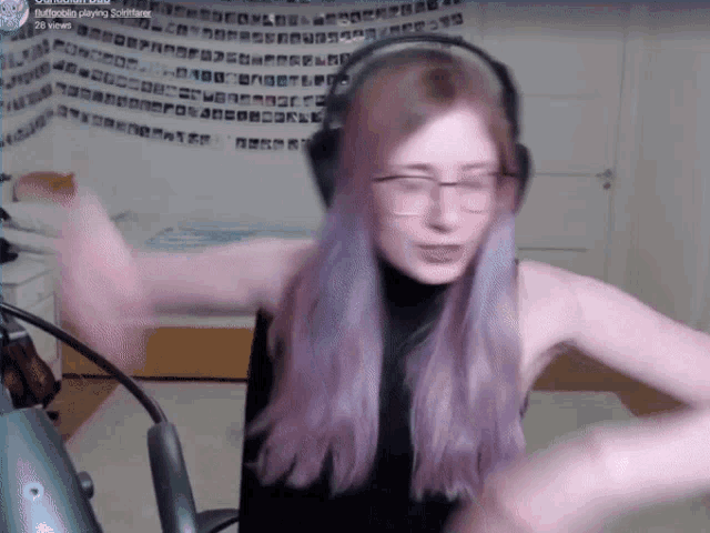 a woman with purple hair and glasses is playing a video game