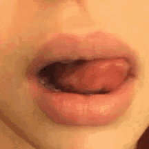 a close up of a person 's mouth with their tongue hanging out .