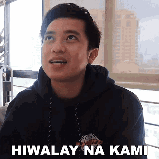 a man wearing a black hoodie with the words hiwalay na kami written on it