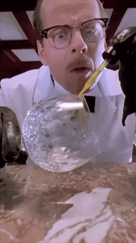 a man with glasses and a mustache is pouring liquid into a glass