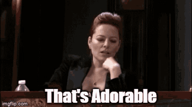 a woman talking on a cell phone with the words that 's adorable on the bottom