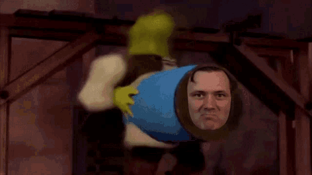shrek is holding a blue cylinder with a man 's face in it