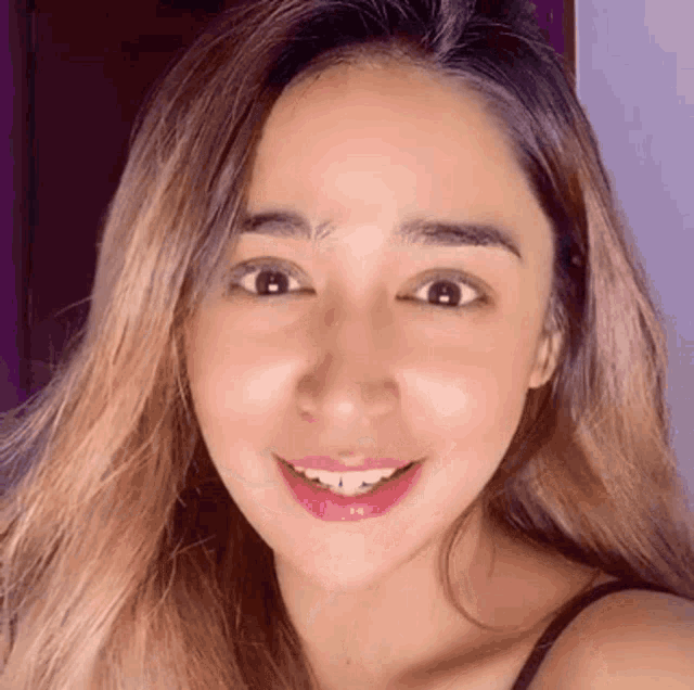 a close up of a woman 's face smiling