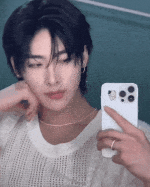 a man taking a picture of himself in a mirror