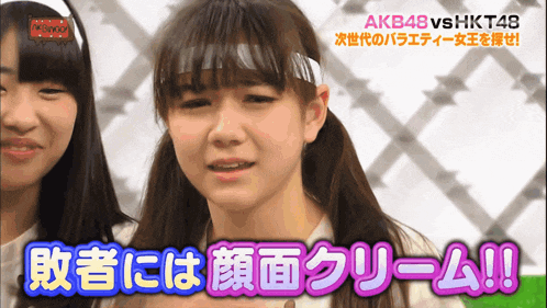 a girl with a bandana on her head says akb48 vs hkt48 in pink letters