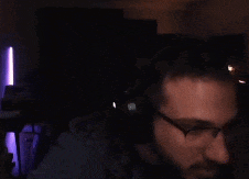 a man wearing glasses and headphones looks at something
