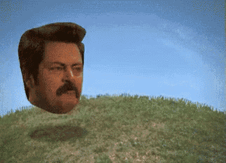 a man with a mustache is floating in the air on top of a grassy hill
